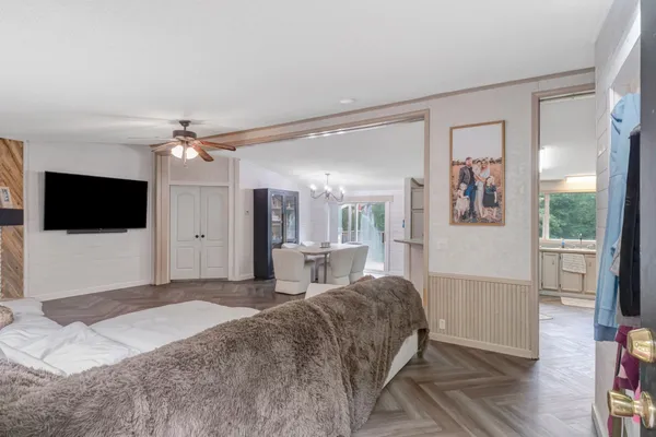 a living room with a flat screen tv and a refrigerator