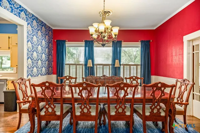 a view of a dining room with furniture and window