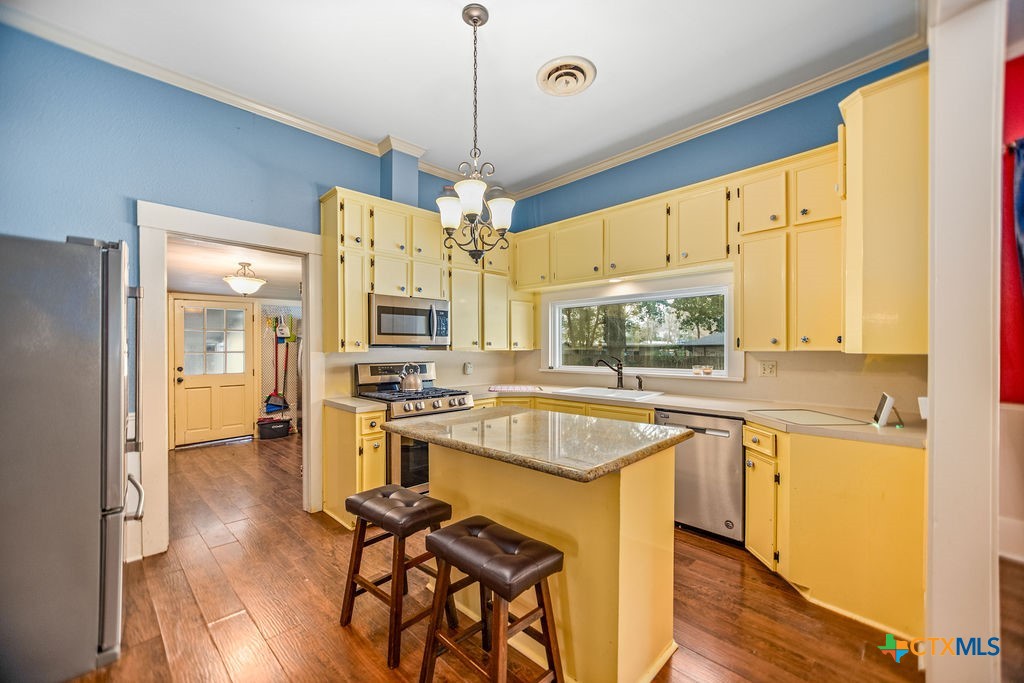 407 Robinson Street Edna, TX 77957 - Photo 17 of 41 a kitchen with stainless steel appliances granite countertop a sink stove and refrigerator