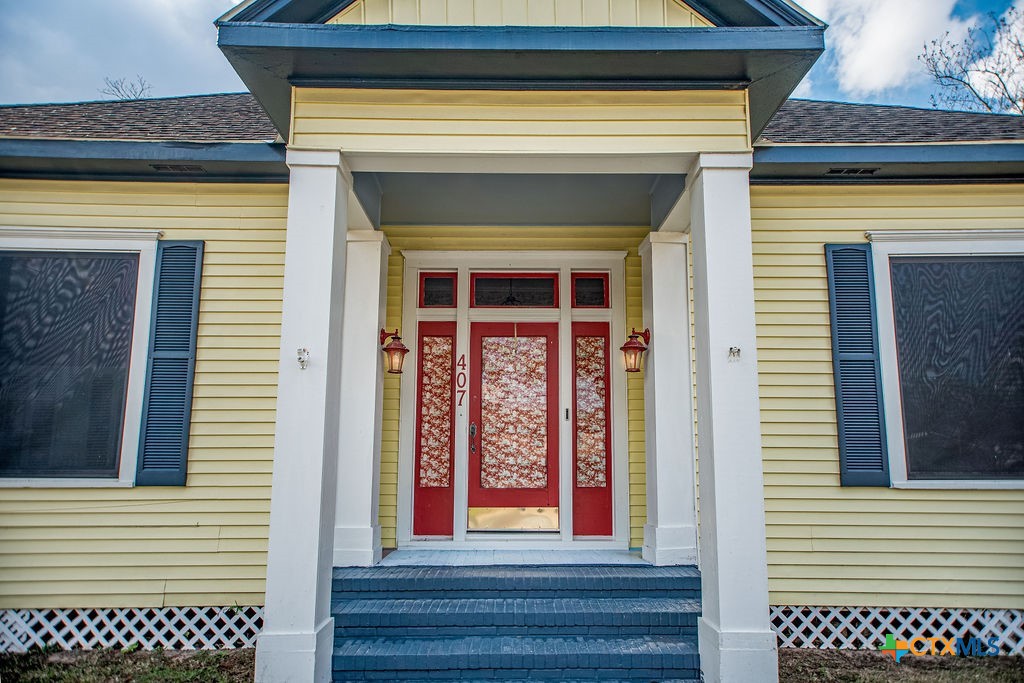 407 Robinson Street Edna, TX 77957 - Photo 2 of 41 a front view of a house with entryway