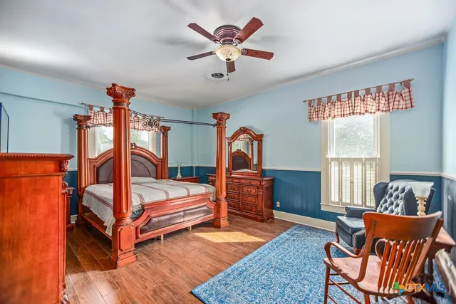 a bedroom with furniture and a window