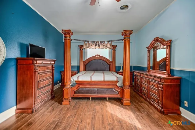 a living room with furniture a flat screen tv and a dresser