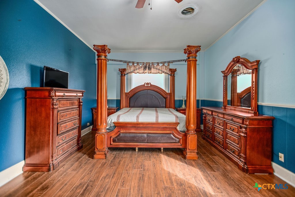 407 Robinson Street Edna, TX 77957 - Photo 22 of 41 a living room with furniture a flat screen tv and a dresser