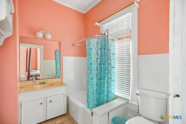a bathroom with a double vanity sink toilet and shower