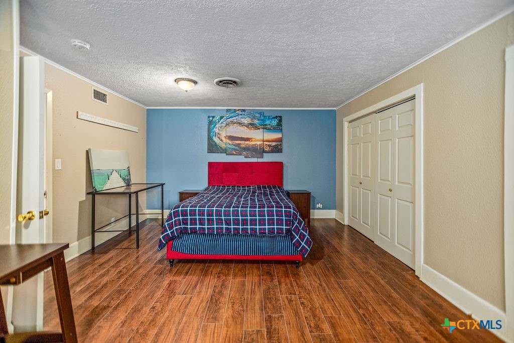 407 Robinson Street Edna, TX 77957 - Photo 27 of 41 a living room with furniture fireplace and wooden floor