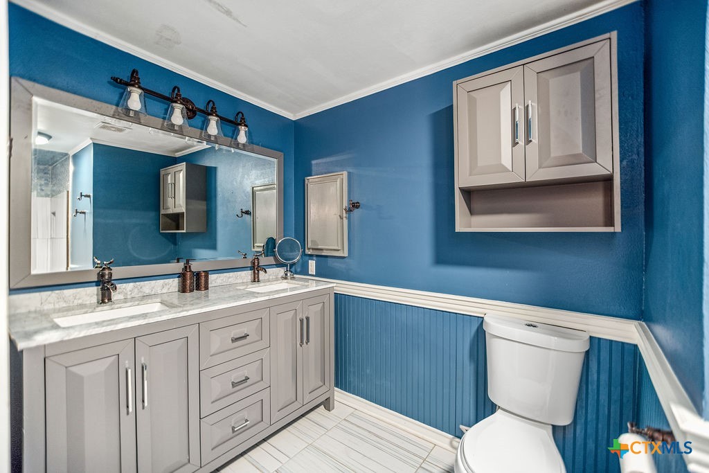 407 Robinson Street Edna, TX 77957 - Photo 28 of 41 a bathroom with a toilet sink and mirror