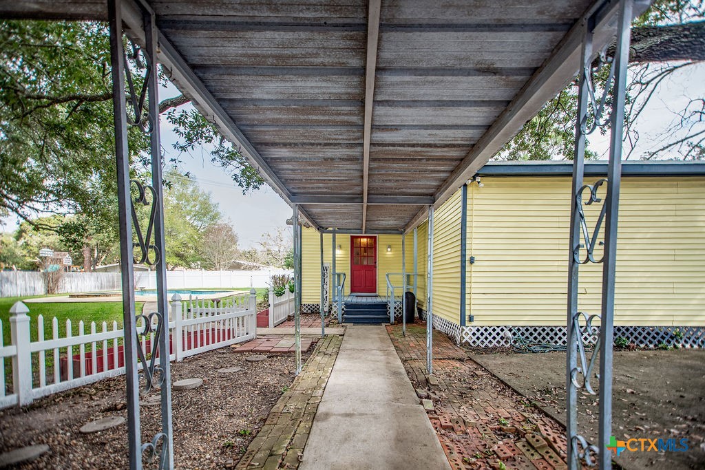407 Robinson Street Edna, TX 77957 - Photo 31 of 41 a porch with a table and chairs next to a yard