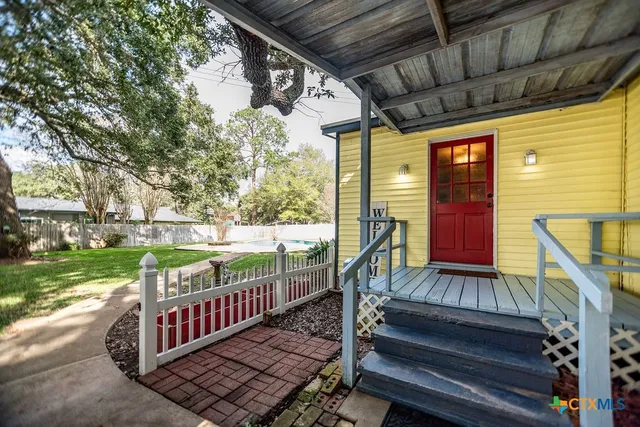 a view of balcony with wooden floor and fence