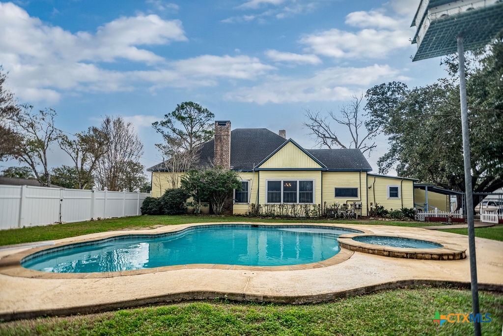 407 Robinson Street Edna, TX 77957 - Photo 37 of 41 a view of a house with swimming pool and a yard