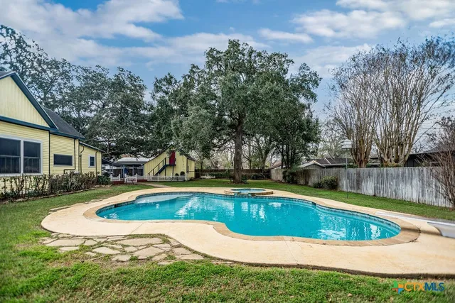 a view of a swimming pool with a patio