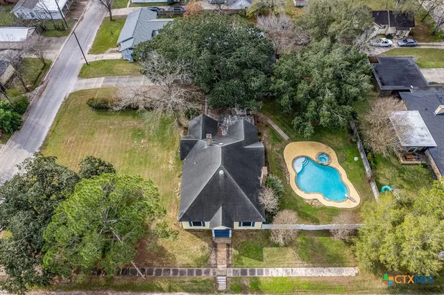 an aerial view of a house with a swimming pool