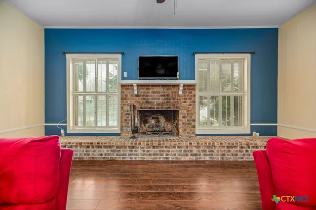 a living room with furniture window and a fireplace