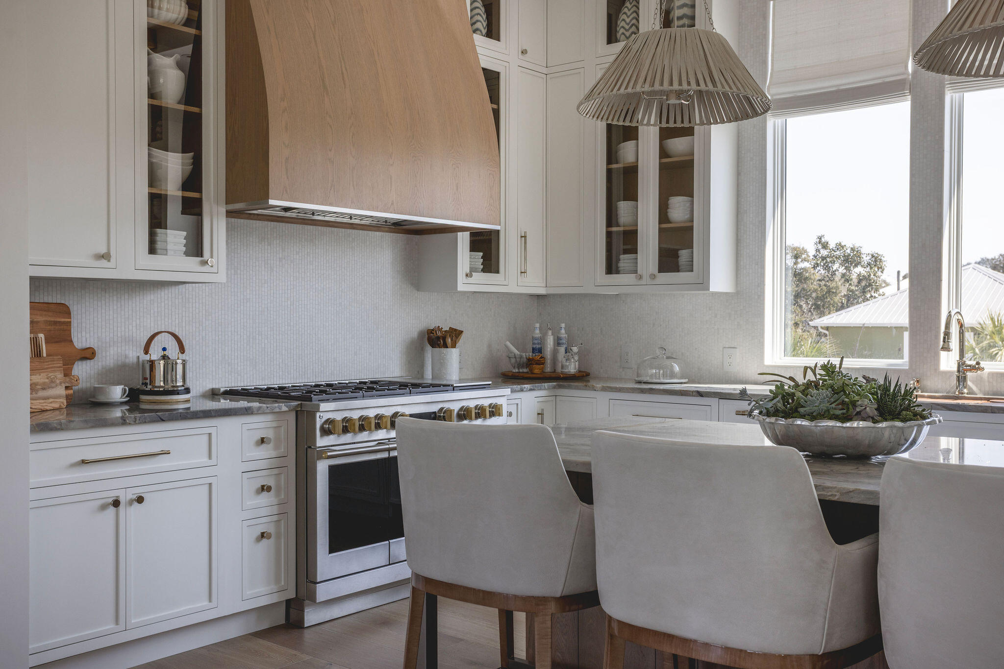 153 Gulf Point Road Santa Rosa Beach, FL 32459 - Photo 11 of 18 a kitchen with stainless steel appliances white cabinets a table and chairs