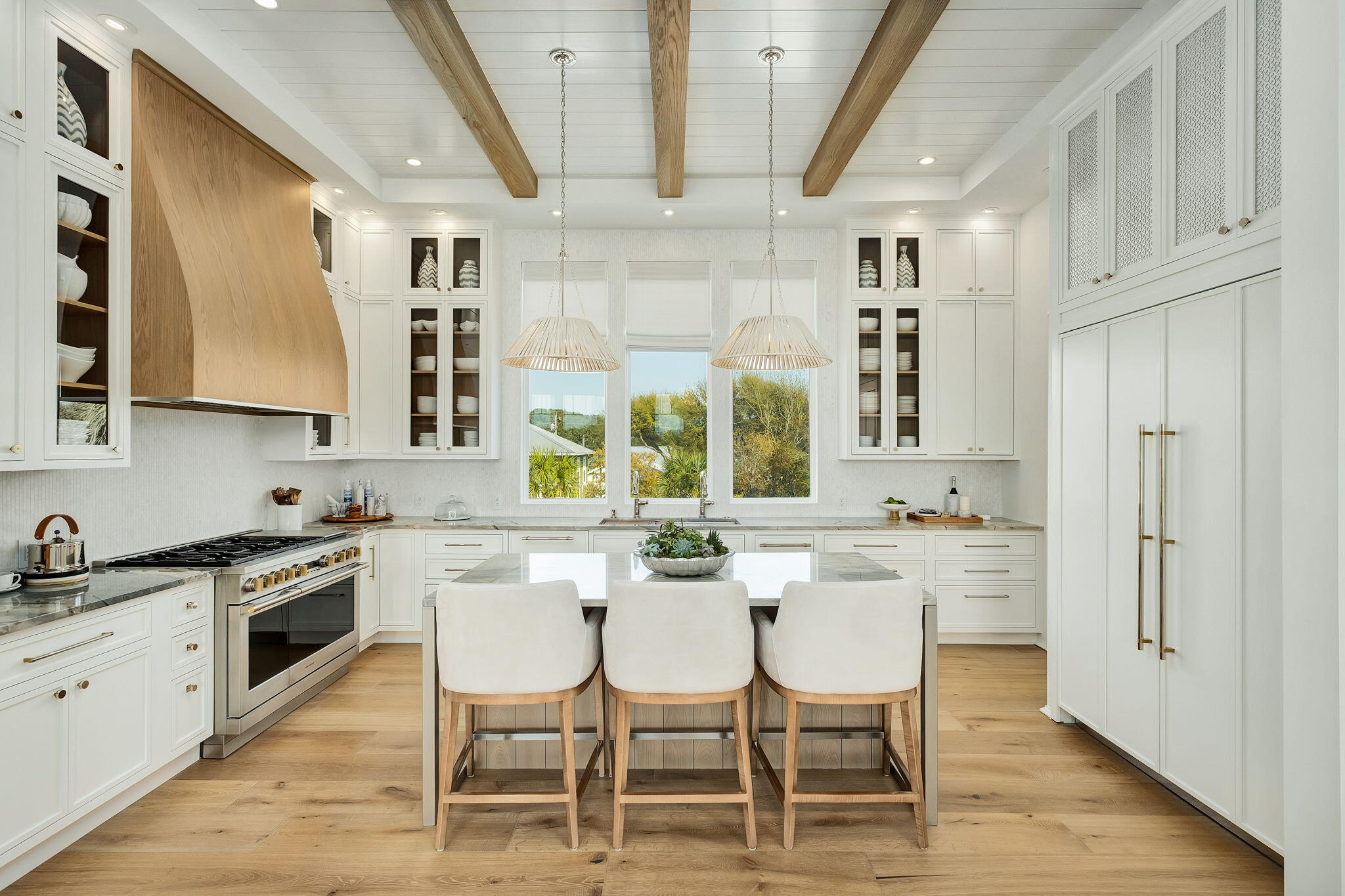 153 Gulf Point Road Santa Rosa Beach, FL 32459 - Photo 10 of 18 a kitchen with stainless steel appliances a dining table chairs and sink