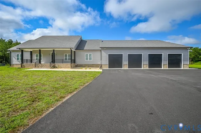 a front view of a house with a garden and yard