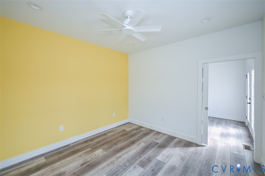 4141 Charles City Road Henrico, VA 23231 - Photo 12 of 35 an empty room with wooden floor and a ceiling fan