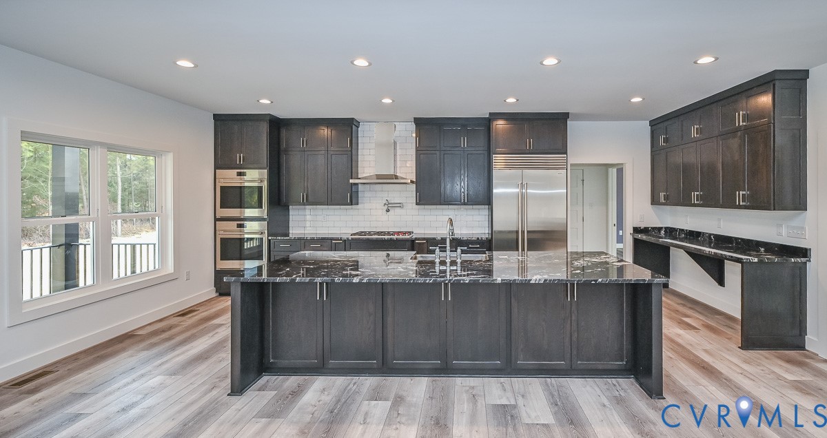 4141 Charles City Road Henrico, VA 23231 - Photo 2 of 35 a kitchen with kitchen island granite countertop wooden cabinets and stainless steel appliances