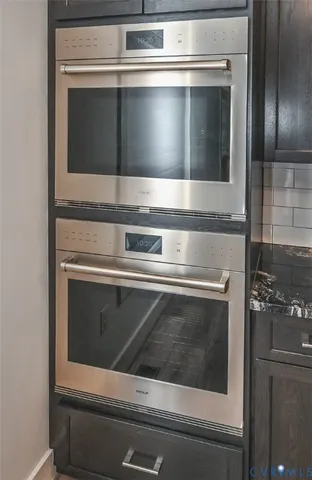 a stove top oven sitting inside of a kitchen
