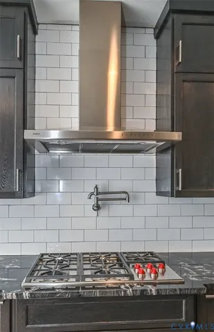 a stove top oven sitting inside of a kitchen