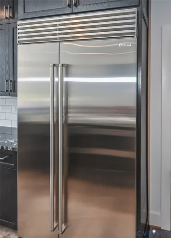 a view of a livingroom with a flat screen tv ceiling fan and window
