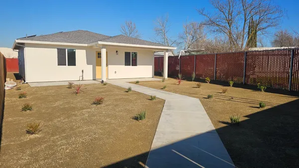 a front view of a house with a yard