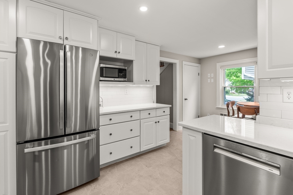 48 Spring Street Wakefield, MA 01880 - Photo 10 of 28 a kitchen with stainless steel appliances granite countertop a refrigerator sink and stove