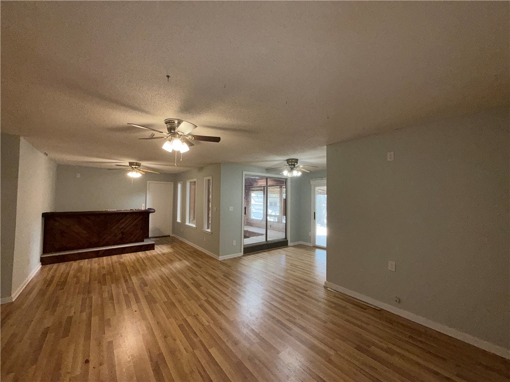 1608 Austin Street Portland, TX 78374 - Photo 16 of 24 a view of an empty room with window and wooden floor