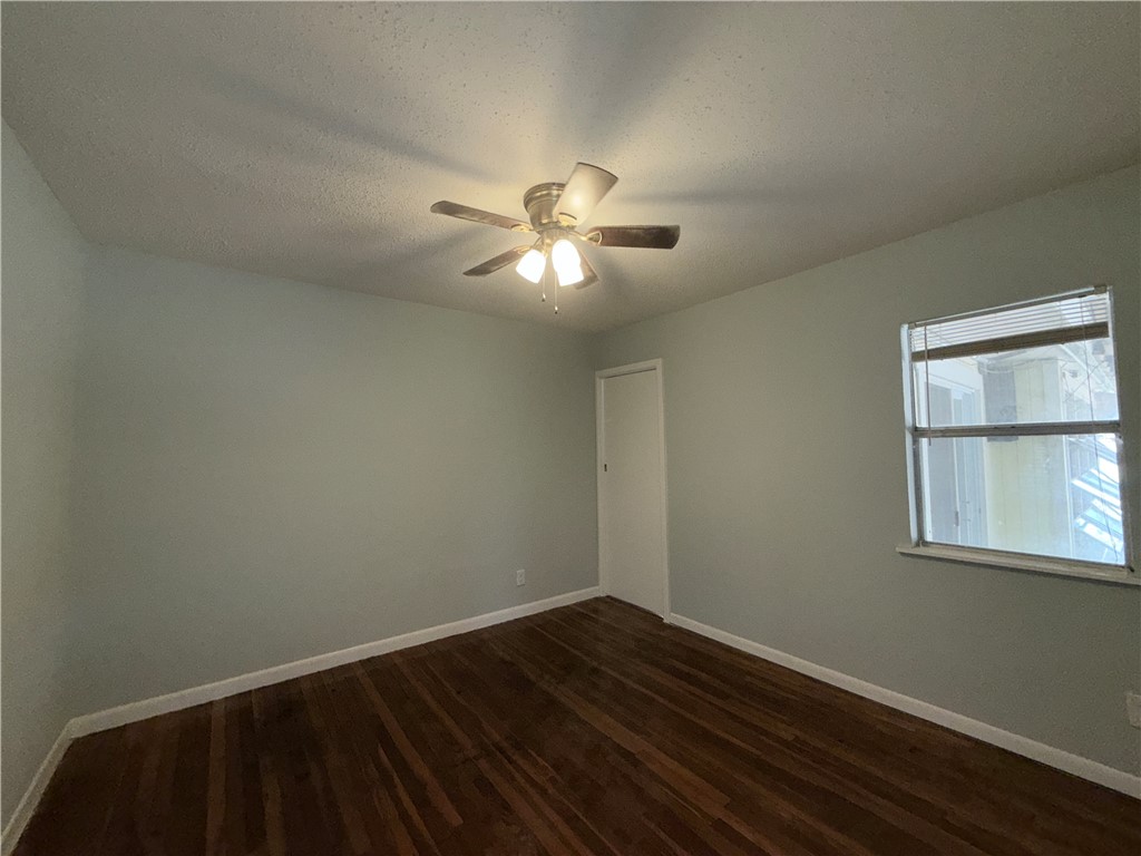 1608 Austin Street Portland, TX 78374 - Photo 19 of 24 a view of a room with wooden floor and a ceiling fan