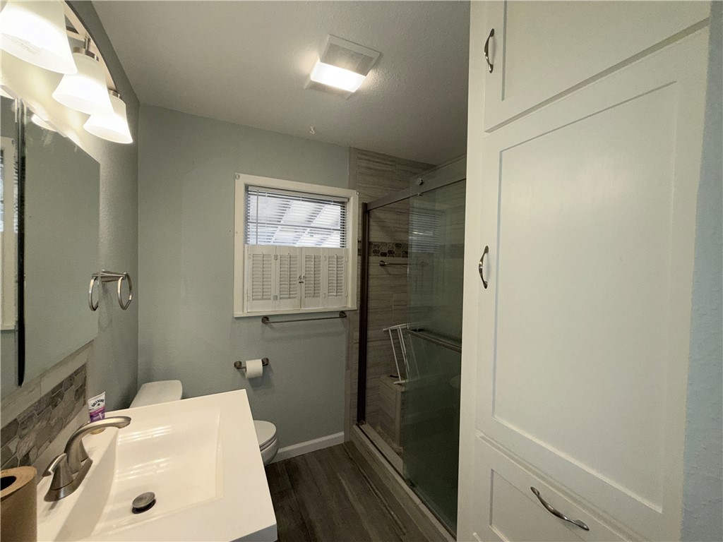 1608 Austin Street Portland, TX 78374 - Photo 20 of 24 a bathroom with a sink a toilet and shower