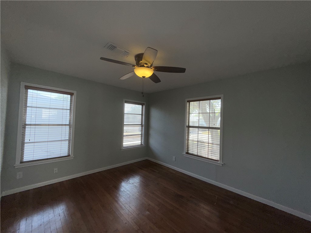 1608 Austin Street Portland, TX 78374 - Photo 6 of 24 an empty room with wooden floor and windows