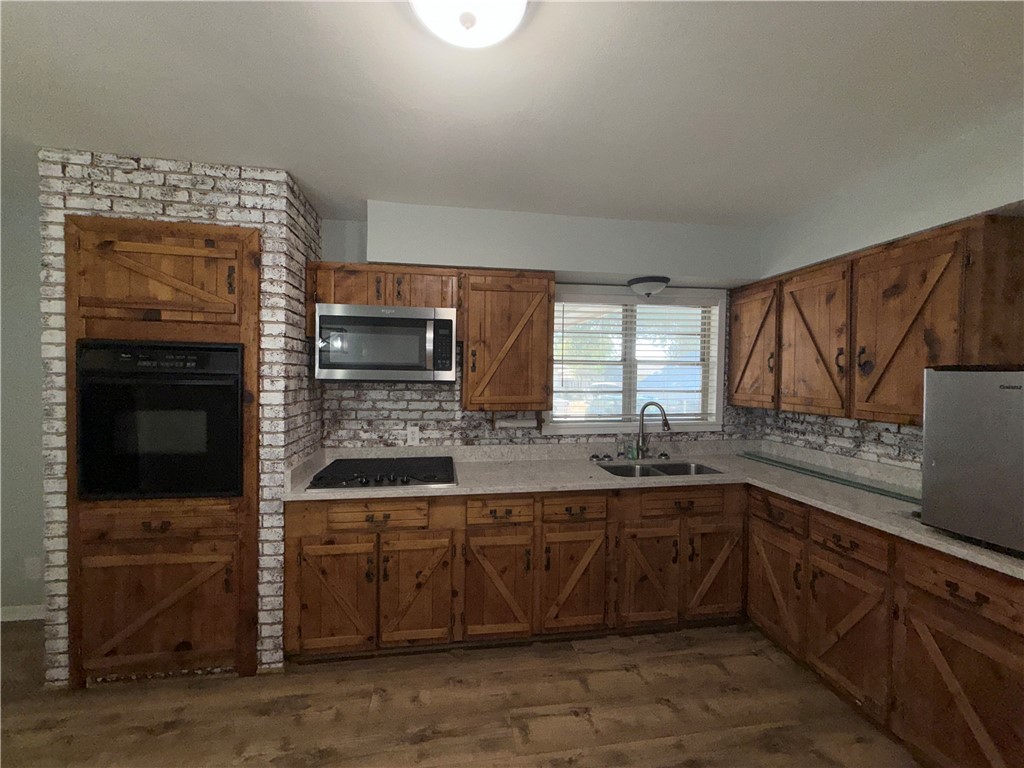 1608 Austin Street Portland, TX 78374 - Photo 7 of 24 a kitchen with a sink and cabinets