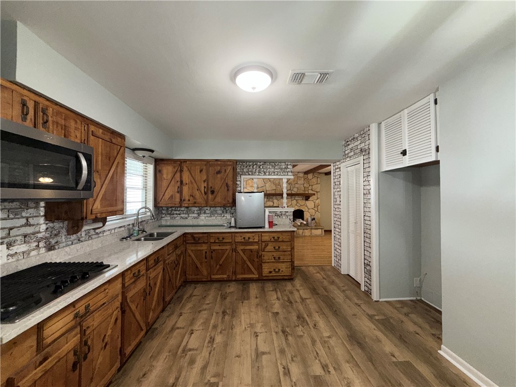 1608 Austin Street Portland, TX 78374 - Photo 9 of 24 a kitchen with a sink appliances and cabinets