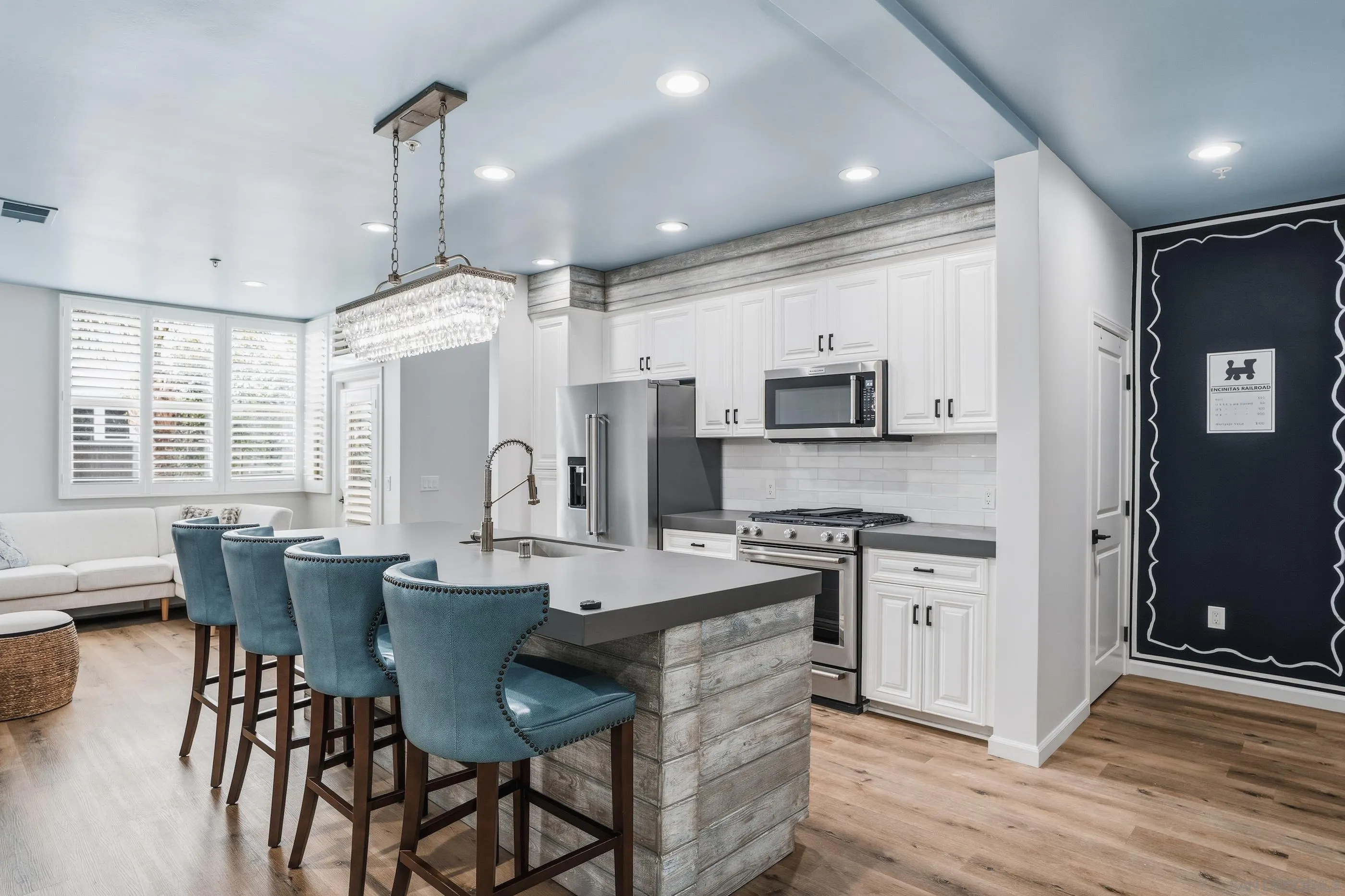 a large kitchen with stainless steel appliances kitchen island granite countertop a stove a sink a dining table and chairs