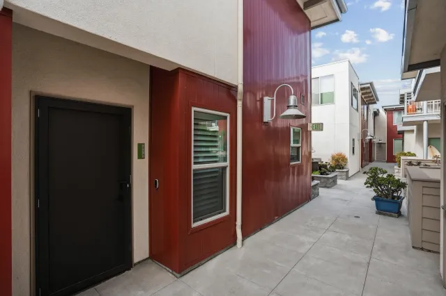 a building outdoor space with patio furniture and potted plants