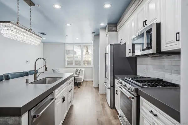 a kitchen with stainless steel appliances granite countertop a sink stove and refrigerator