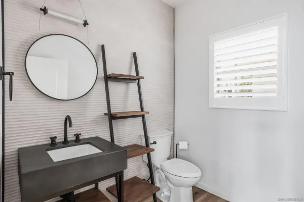 a bathroom with a toilet a sink and a mirror