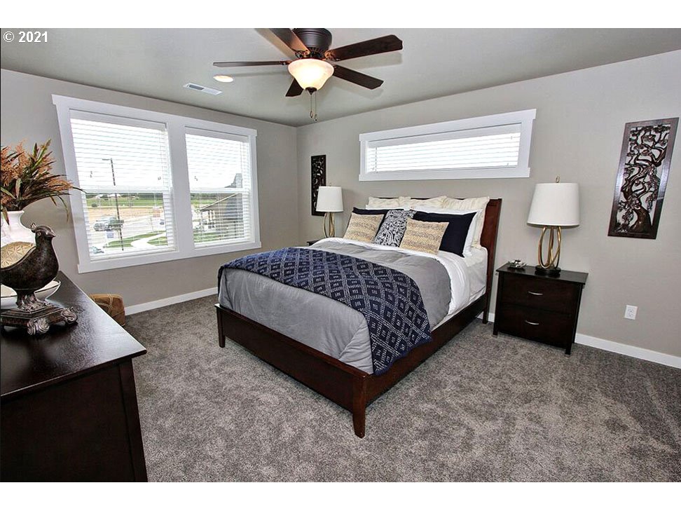 5270 Squirrel Street Springfield, OR 97478 - Photo 4 of 8 a spacious bedroom with a bed and a window