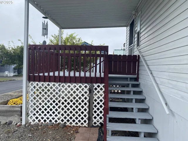 a view of a balcony with wooden floor
