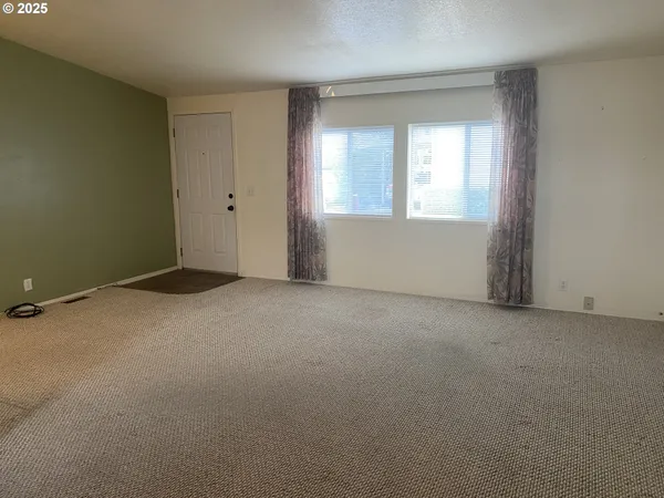 an empty room with closet and mirror