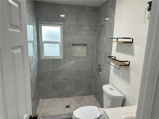 a bathroom with a toilet and a shower