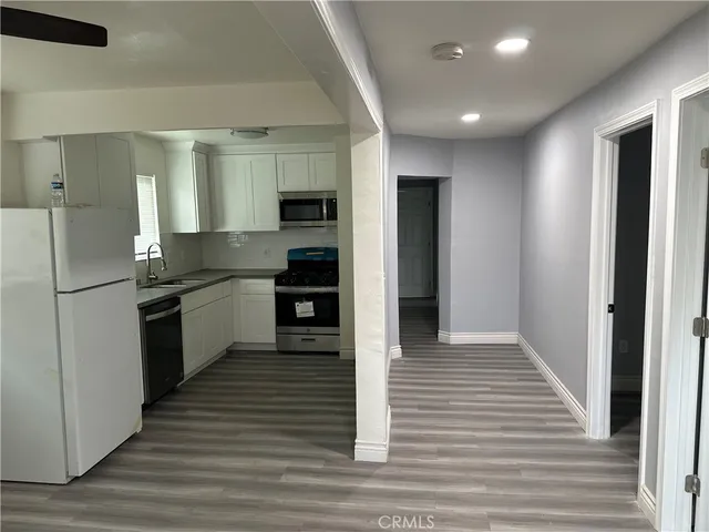 a view of hallway with wooden floor