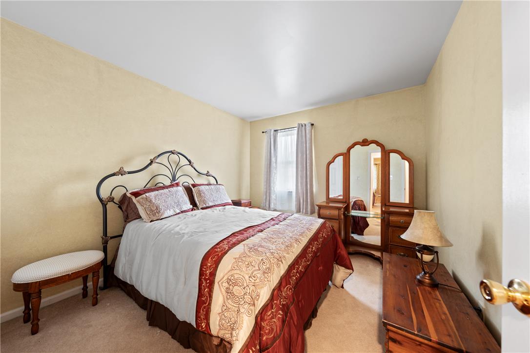 4568 Greenfield Road Bethlehem, PA 18017 - Photo 30 of 59 A comforting bedroom space features soft carpet flooring and a sun-filled window, ideal for quiet relaxation.