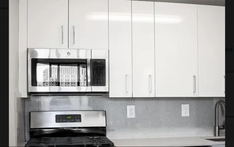 a kitchen with a refrigerator and window