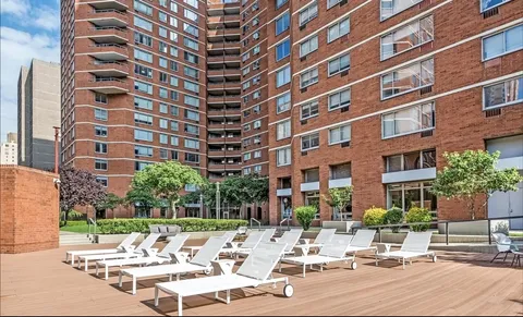 a view of a building with garden and sitting area