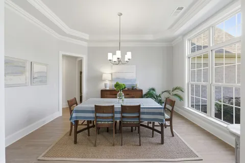 a view of a dining room with furniture window and outside view