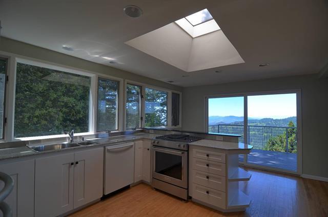 254 Swett Road Woodside, CA 94062 - Photo 5 of 24 a kitchen with a stove a sink and a large window