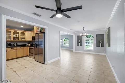 a kitchen with granite countertop a refrigerator and a stove top oven