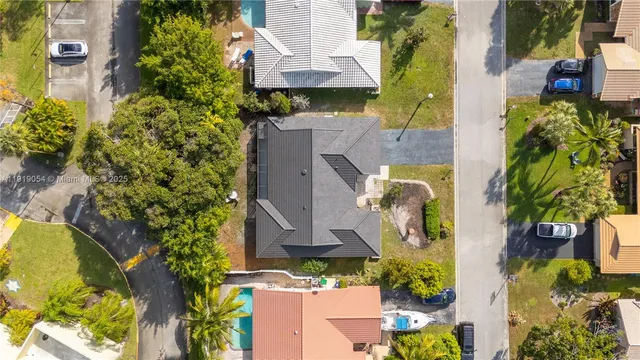 an aerial view of a house with a yard and garden