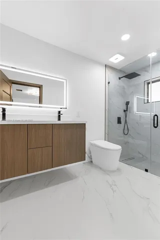a bathroom with a bathtub sink mirror and toilet
