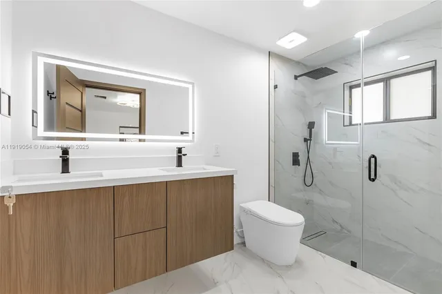 a bathroom with a sink toilet and shower